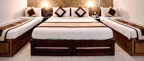 A modern hotel room with a large bed, a ceiling fan, and a marble floor.