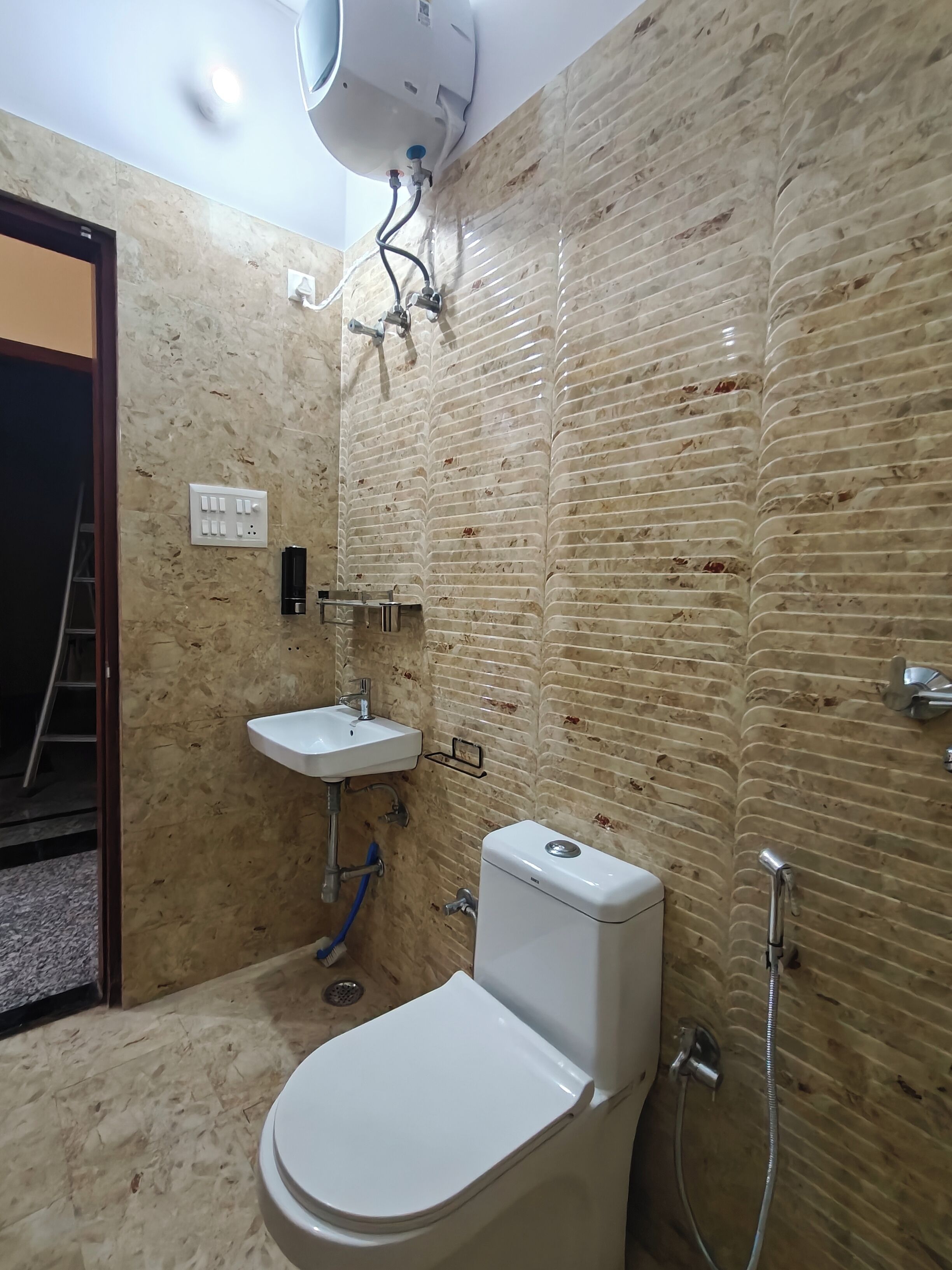 A bathroom with a toilet, sink, and shower.