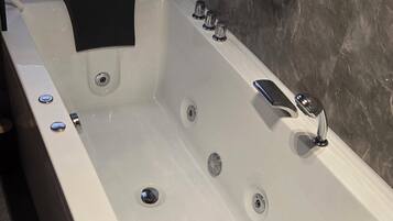 Jetted tub, soap, toilet paper