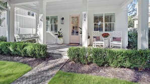 A covered porch with a white exterior, a mailbox, and a number '294' on the wall. - 3 bedroom/3.5 bath house.  Master on the main!  South end. (Saint Simons Island)