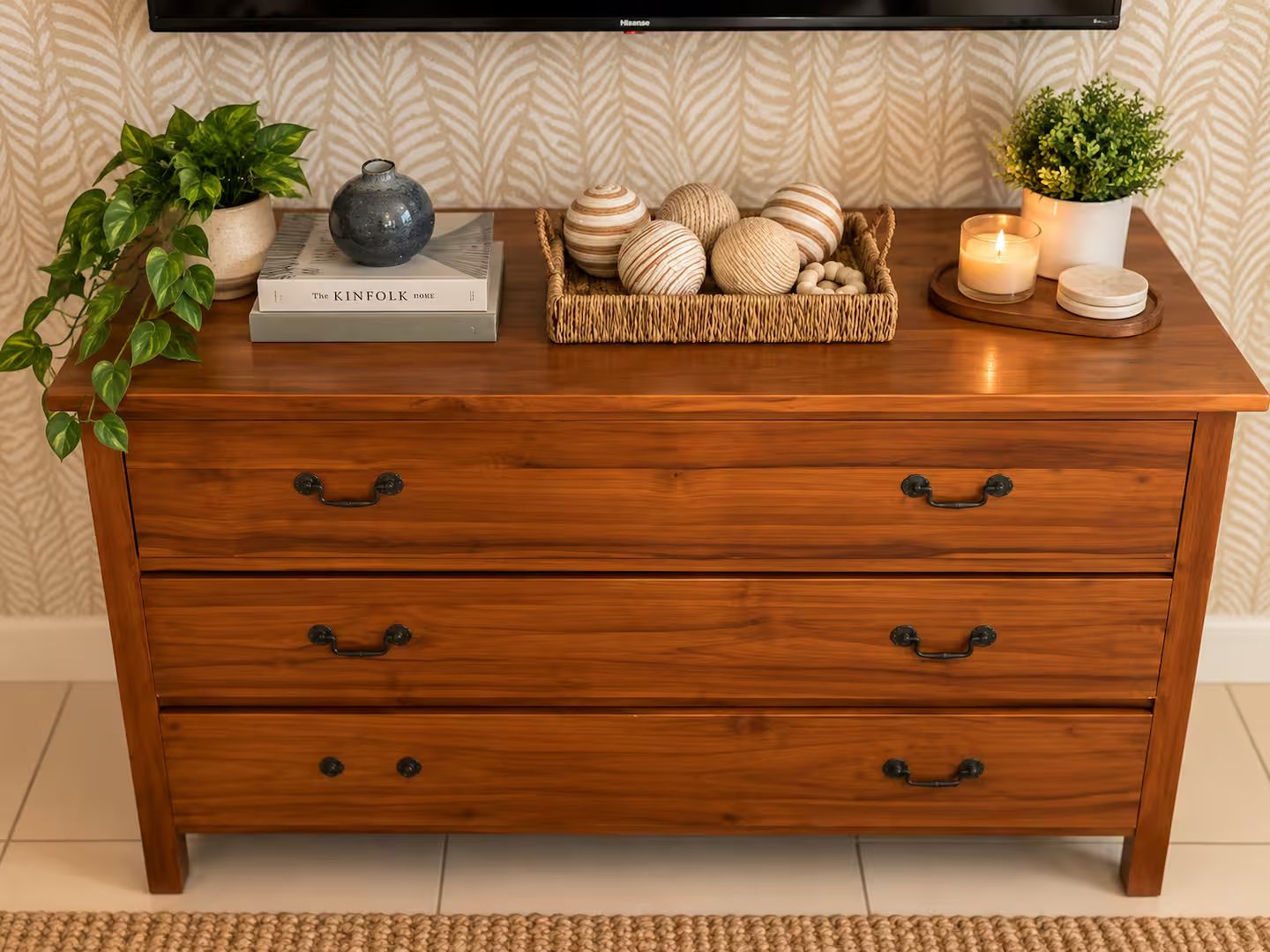 Keep belongings organized in a stylish wooden dresser with room for essentials.