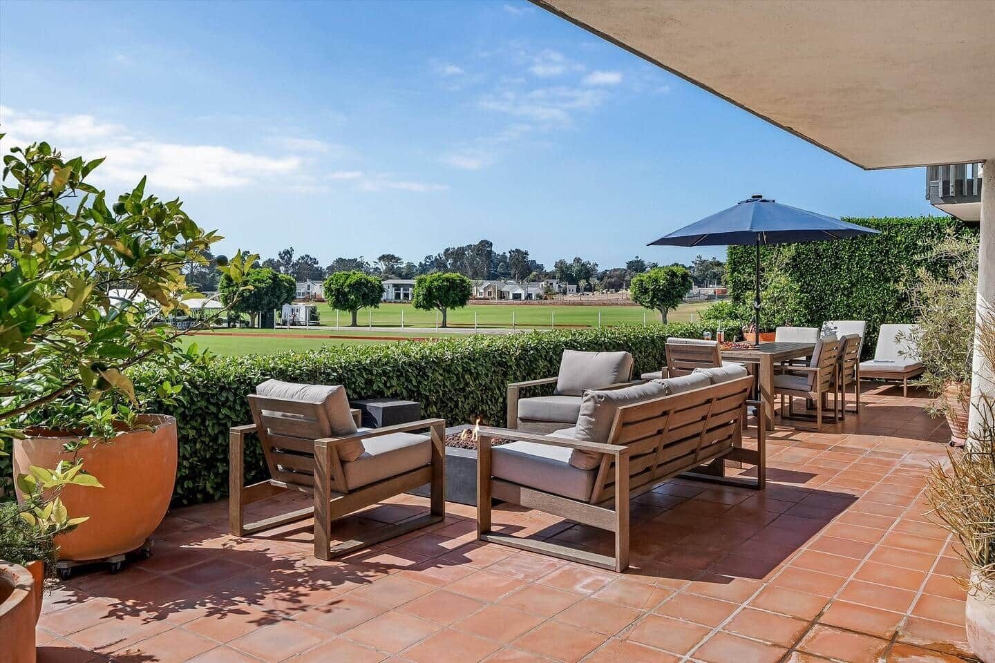 An outdoor patio area with seating and a view of a golf course.