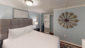 A bedroom with a large bed, a headboard, a wall clock, and a closet with shelves. - 4297 Earney Rd, Unit 3, Woodstock (Woodstock)