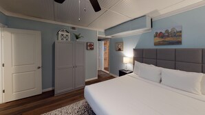 A bedroom with a bed, a nightstand, a lamp, a wardrobe, and a painting on the wall. - 4297 Earney Rd, Unit 3, Woodstock (Woodstock)
