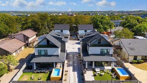 A residential area with modern houses, a central walkway, and two swimming pools. - Sleeps 20, 5br Pool table, Chef's Kitchen, Pool (Austin)