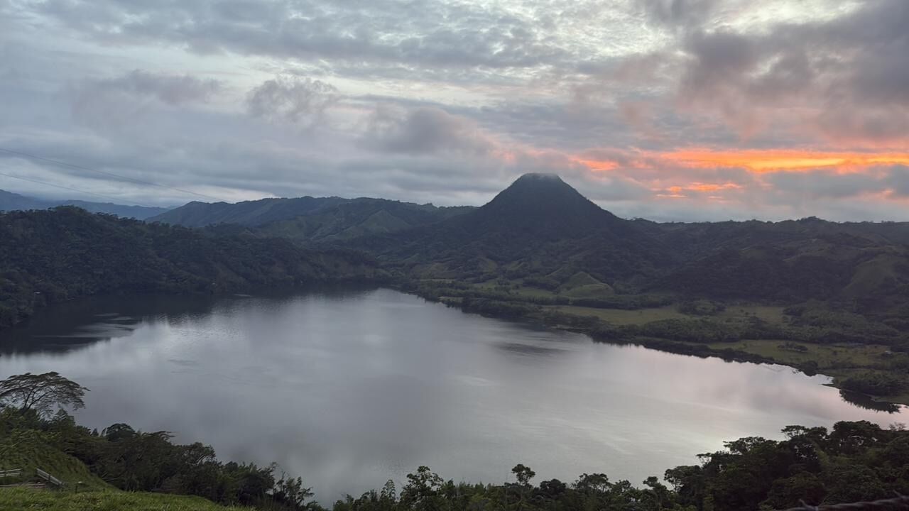 A mountainous landscape with a lake and a prominent peak.