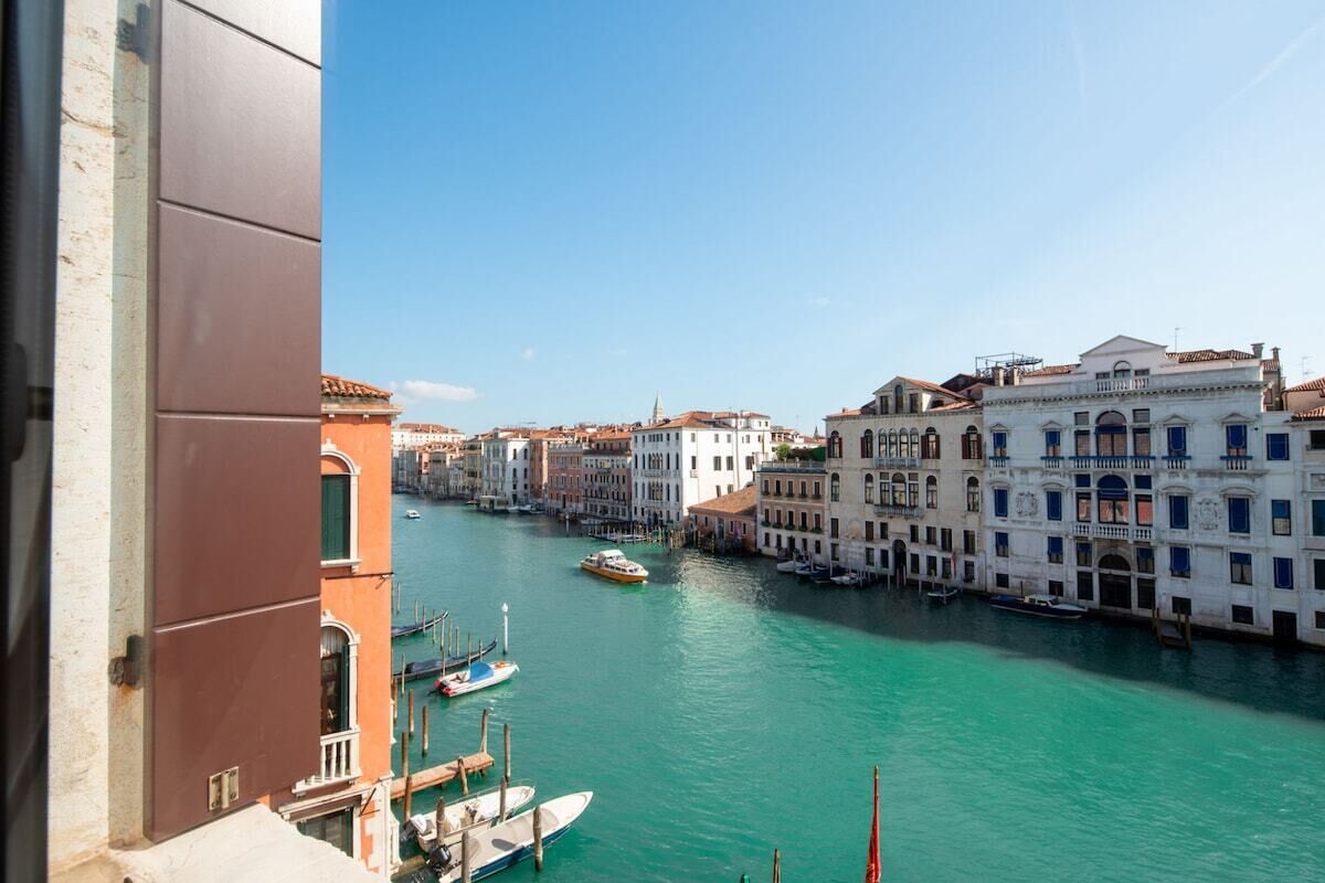 A canal with buildings on one side and a clear sky.