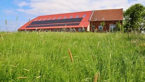 Un edificio con techo rojo y paneles solares.