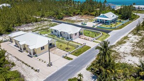 A coastal property with multiple buildings, a paved road, and a view of the ocean.