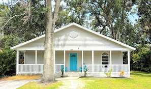 A single-story house with a gabled roof, a front porch with white railings, and a blue door. - Walk to Bay&Downtown/Lido Beach&St. Armands 3.7mi/Siesta Key 7mi/Firepit/Kayaks (Sarasota)