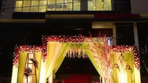 A hotel named HOTEL BENSEN with a modern facade, a red carpet entrance, and a sign for ROYAL ENTERED. - Hotel Bensen (Puri)