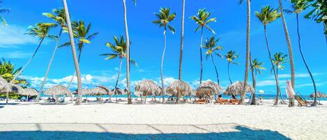 On the beach, white sand, beach towels, beach massages