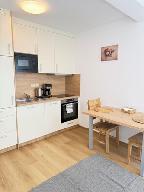 Family Studio | Private kitchen | Toaster, highchair, coffee grinder, freezer