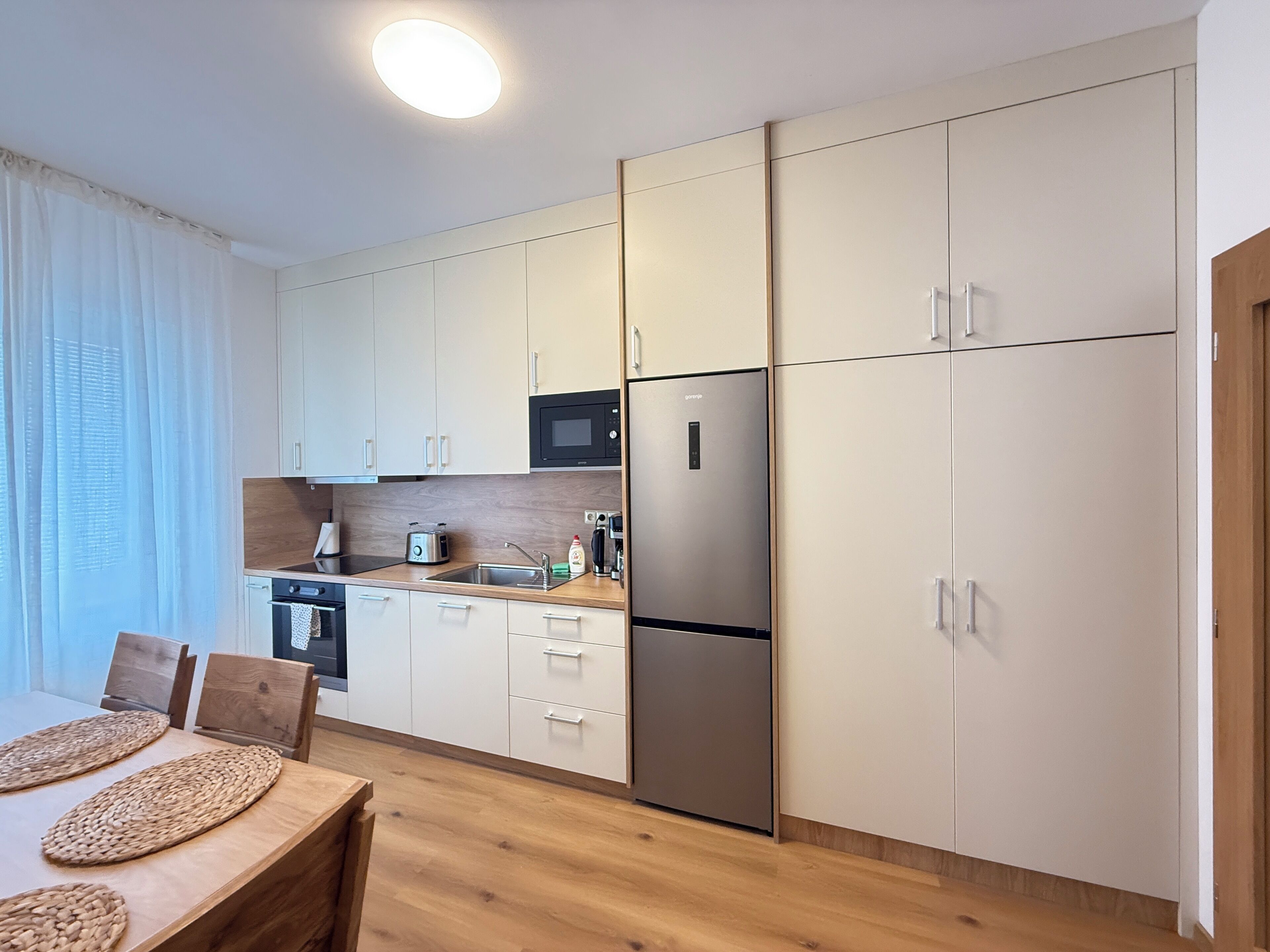 Comfort Apartment | Private kitchen | Toaster, highchair, coffee grinder, freezer