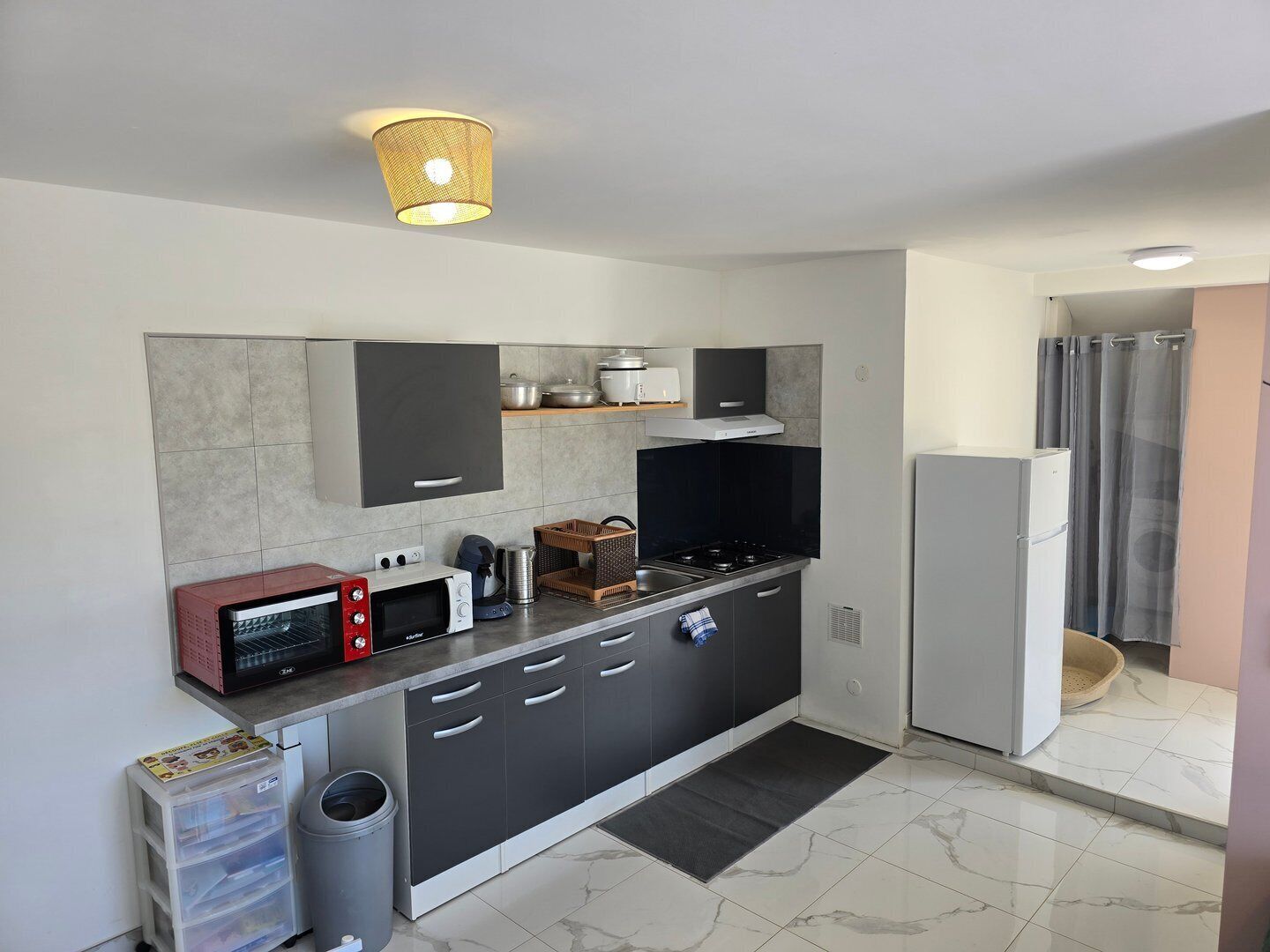 A modern kitchen with a microwave, stove, and refrigerator.