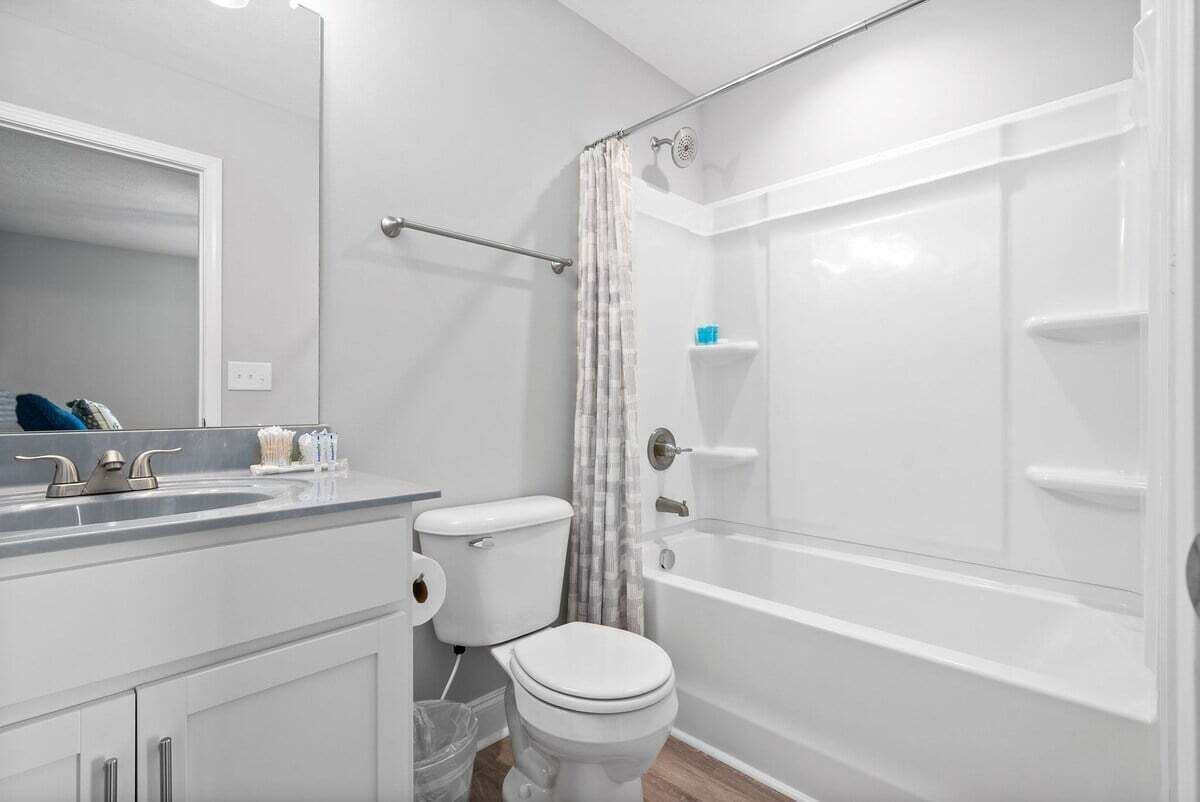 Une salle de bain équipée de toilettes, d’un lavabo et d’une douche.