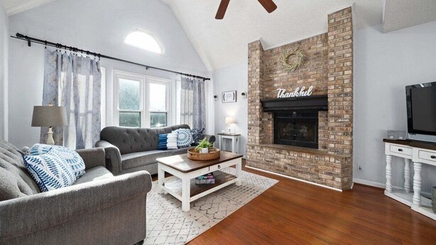 A living room with a fireplace, a sofa, a coffee table, and a television. - Hudson House - 0.2 Miles to Red River (Clarksville)