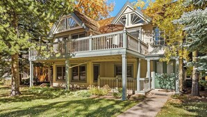 A two-story house with a balcony, a porch, and a front door. - West End Splendor by Snowmass Vacations (Aspen)