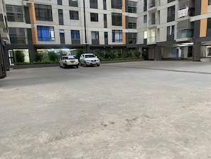A multi-story parking garage with two cars parked.