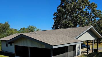 A single-story building with a covered garage and a small pavilion.