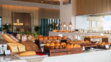 A bakery display with various breads and pastries.