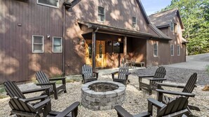 A wooden building with a porch, outdoor seating, and a fire pit. - Deep Forest Dream- Aunt Susies Raystown Lake (James Creek)