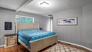A bedroom with a bed, a nightstand, a window, and a framed picture on the wall. - Deep Forest Dream- Aunt Susies Raystown Lake (James Creek)