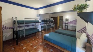 A dormitory room with bunk beds, a small desk, and a chair. - Located in downtown Morelia, 4 blocks from the imposing Cathedral. (Morelia)