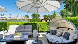 A patio with a sofa, a round seating area, and a table with a plant. - Luxury Retreat ✨ Views, Heated Pool+ Spa Baths.♥️smart bidet (Palm Desert)