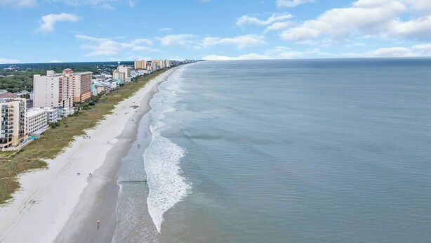 A coastal cityscape with a long beach, high-rise buildings, and a clear sky. - Holly House / Poolside Getaway / Near the Beach (North Myrtle Beach)