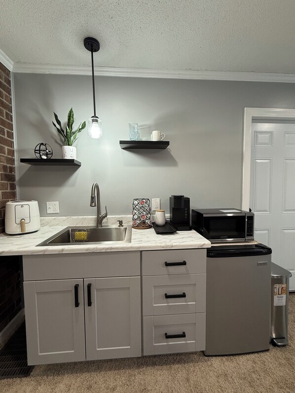Fridge, microwave, coffee/tea maker, cookware/dishes/utensils