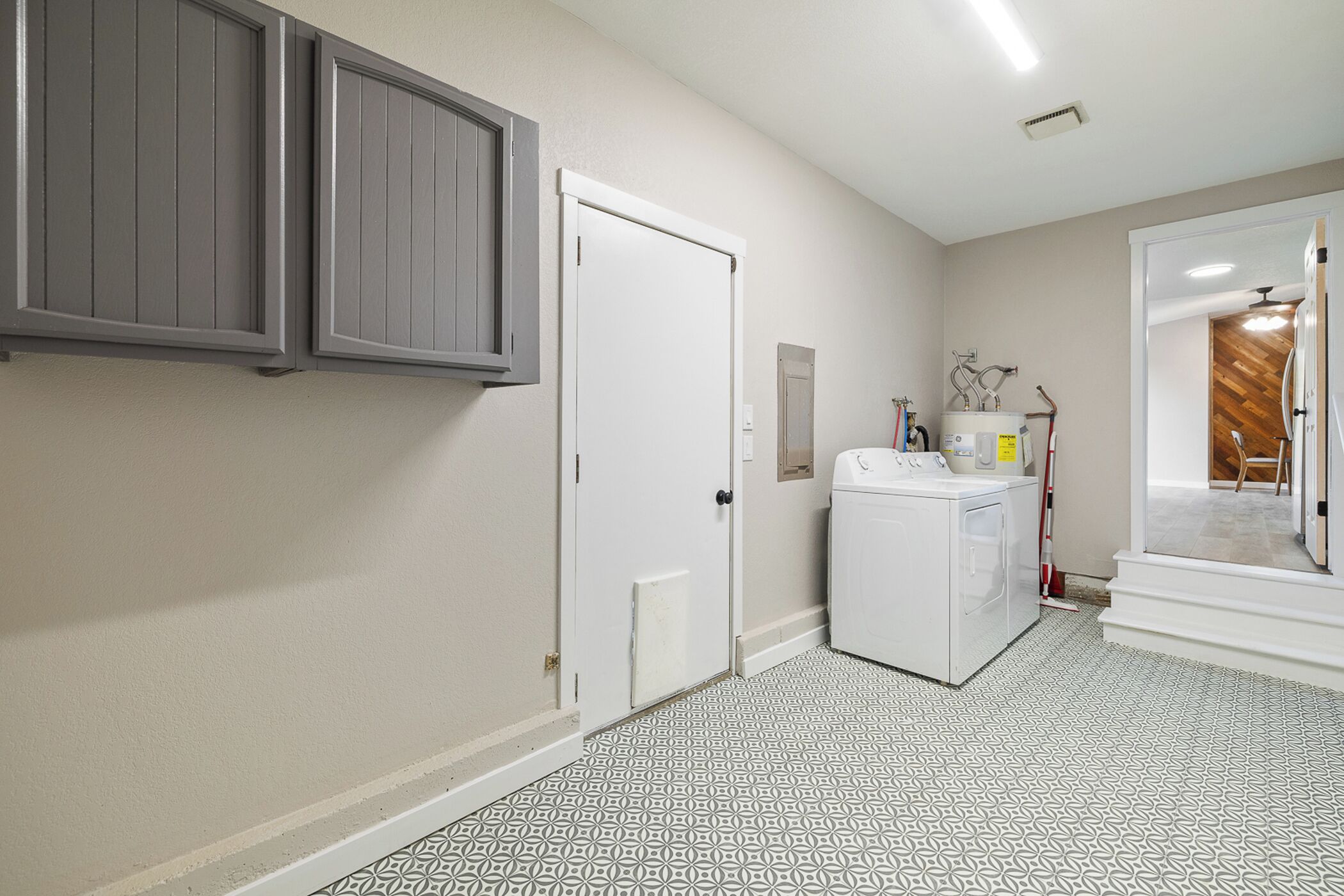 A laundry room with a washing machine, a dryer, and a utility sink.