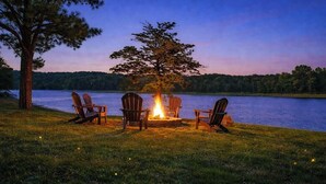 A lakeside setting with a fire pit and Adirondack chairs. - Waterfront Retreat for 8 w/Fire Pit, Boat Dock, no steps to water! 3BR/2BA (Cadiz)