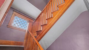 A wooden staircase with a window at the top.