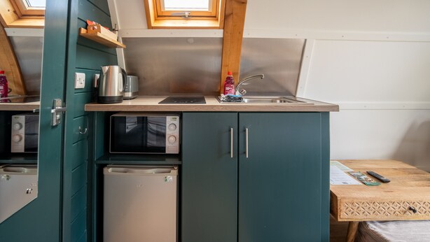 A compact kitchenette with a microwave, refrigerator, and sink. - Romantic Cosy Cabin with Hot Tub in Cumbria (Brampton)