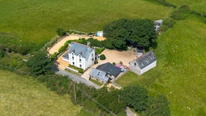 An aerial view of a property with a main house, a smaller building, and a large tree. - Goleufryn - sleeps 20 guests  in 7 bedrooms (Abersoch)