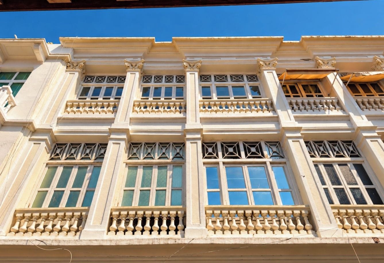 A building facade with multiple windows and balconies.