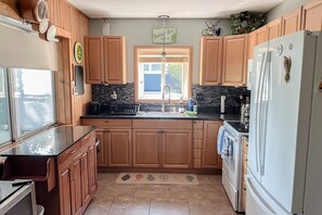 Fridge, microwave, oven, stovetop - Lakefront Retreat | Hot Tub, Firepit, Kayaks, Dock & Spacious Outdoor Living (Mecosta)