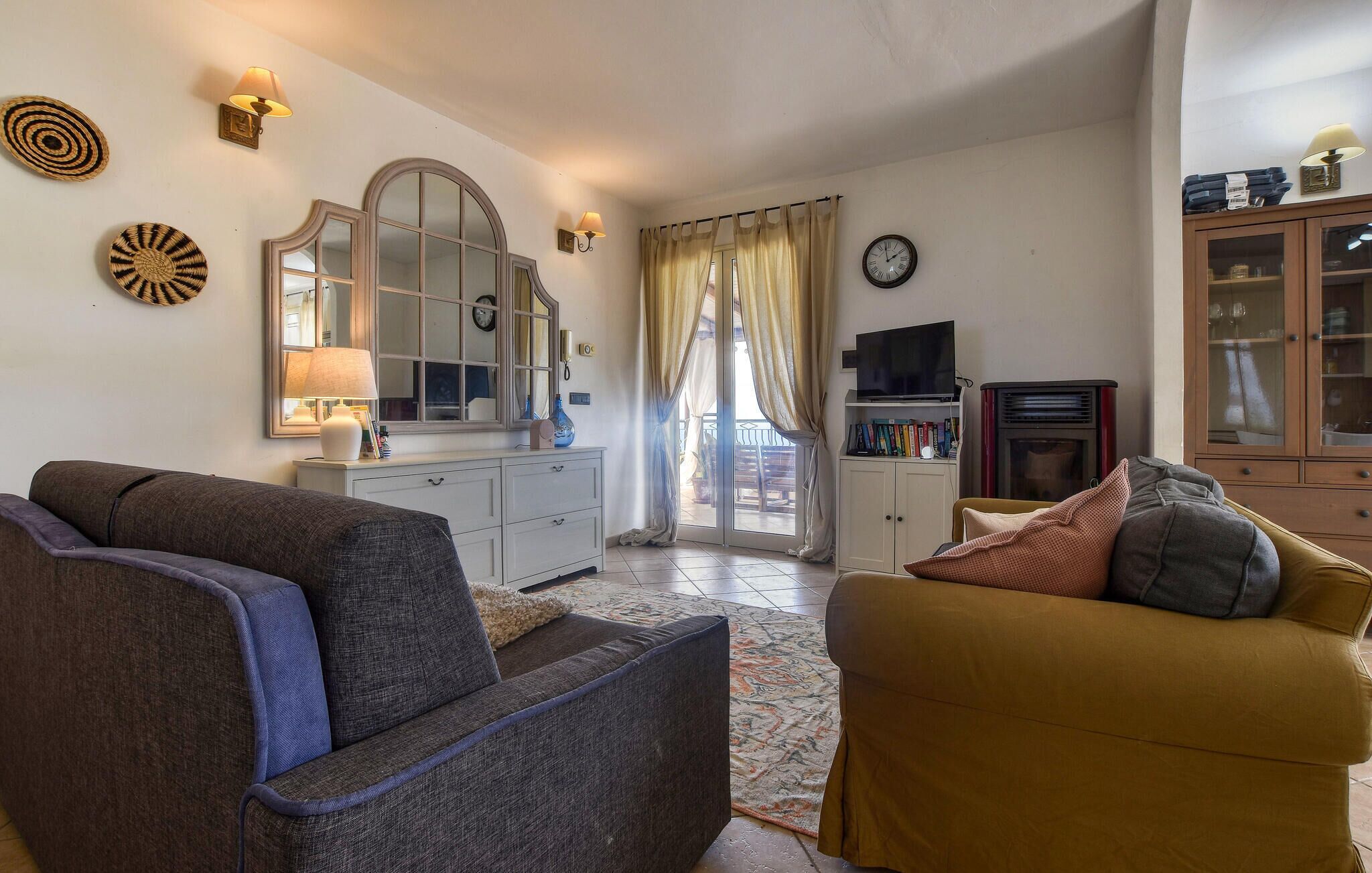 A living room with two sofas, a television, a cabinet, and a fireplace.