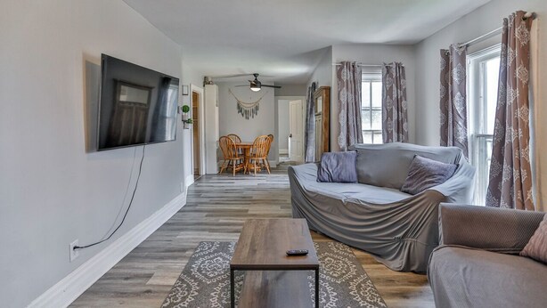 A modern living room with a sofa, coffee table, and TV. - Gowen 2411 - 3BR Mid-Term Stay, All Utilities Incl (Wausau)