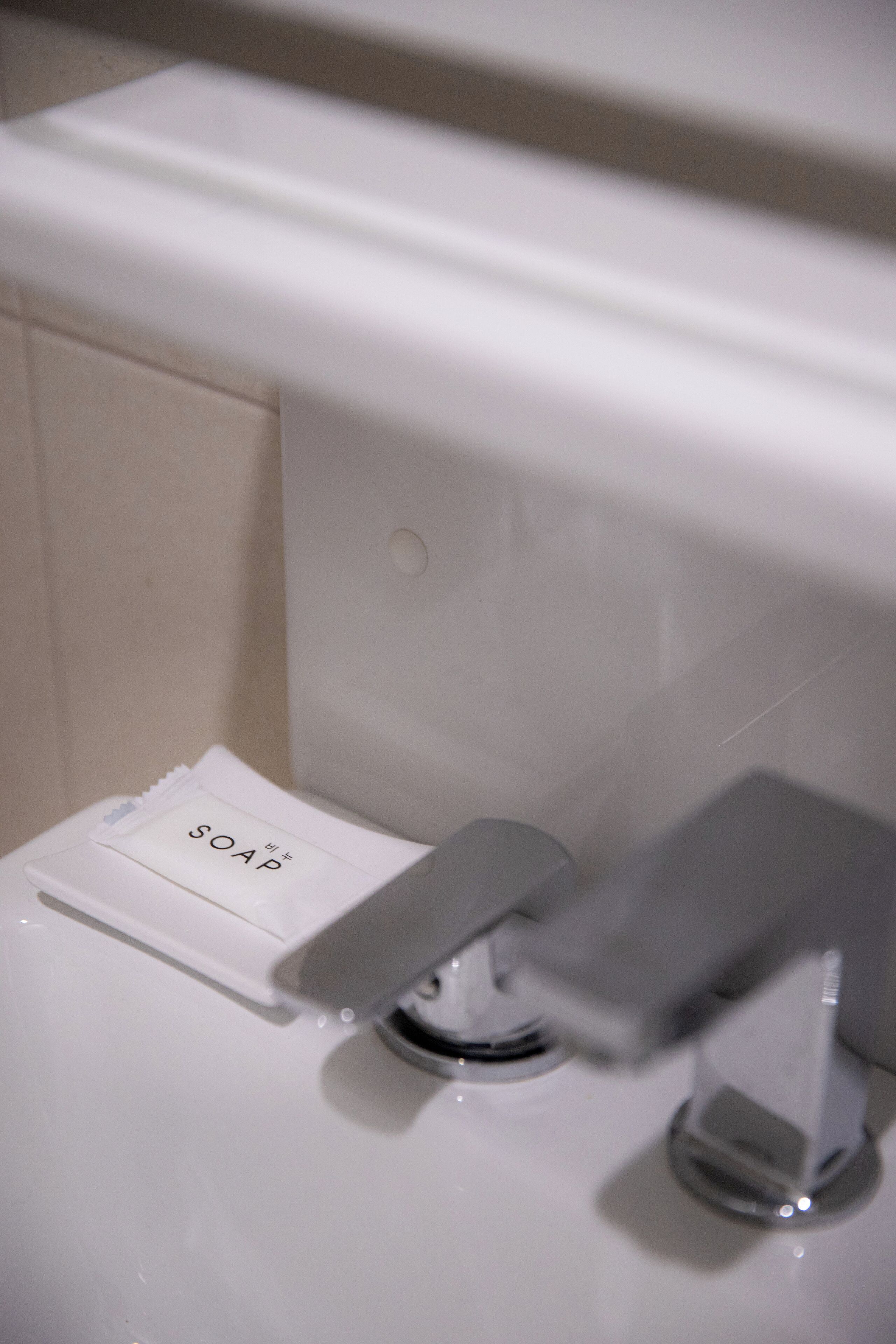 A toilet with a soap dispenser labeled "SOAP" and a bidet attachment.
