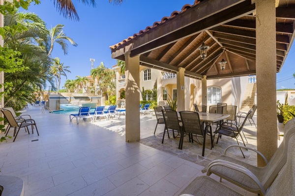 Enjoy the perfect blend of shade and sunshine at the covered poolside table. A cozy spot to sip your morning coffee, share meals, or simply unwind while taking in the serene pool views