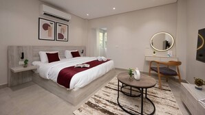 A modern hotel room with a large bed, bedside tables, a round coffee table, a desk with a chair, a mirror, and artwork on the wall. - 88 Escape | Pool • Modern • Prime Spot by spacey (Maadi as Sarayat Al Gharbeyah)