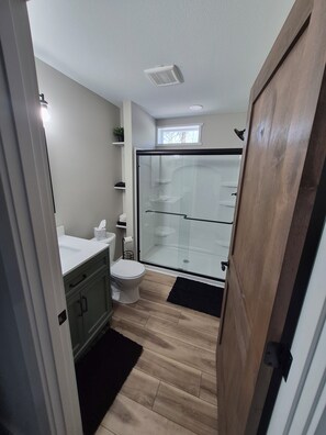 Shower, hair dryer, towels, toilet paper