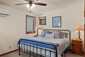 A bedroom with a bed, two bedside tables, a ceiling fan, and two wall-mounted lamps. - Golf Course, Hot Spring Close, Dalton Ranch! (Durango)
