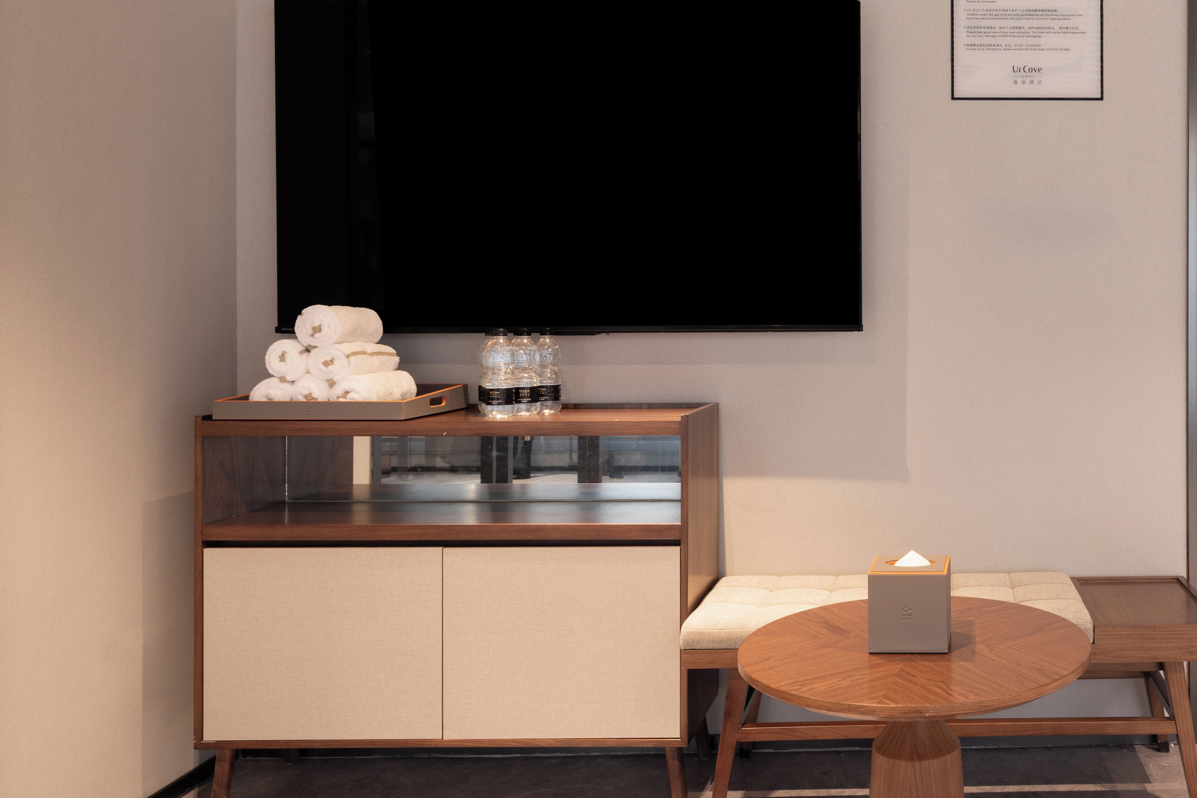 A modern room with a wooden cabinet, a round table, and a sofa.