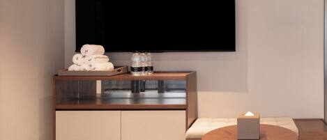 A modern room with a wooden cabinet, a round table, and a sofa.