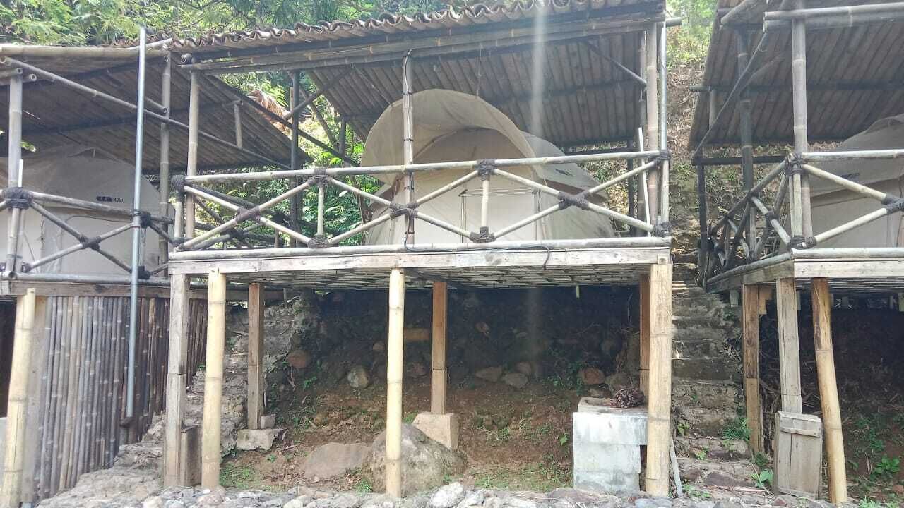 A traditional bamboo structure with a thatched roof, possibly a guesthouse or communal area.