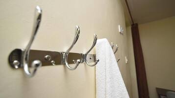 A metal towel rack with a white towel hanging on it.