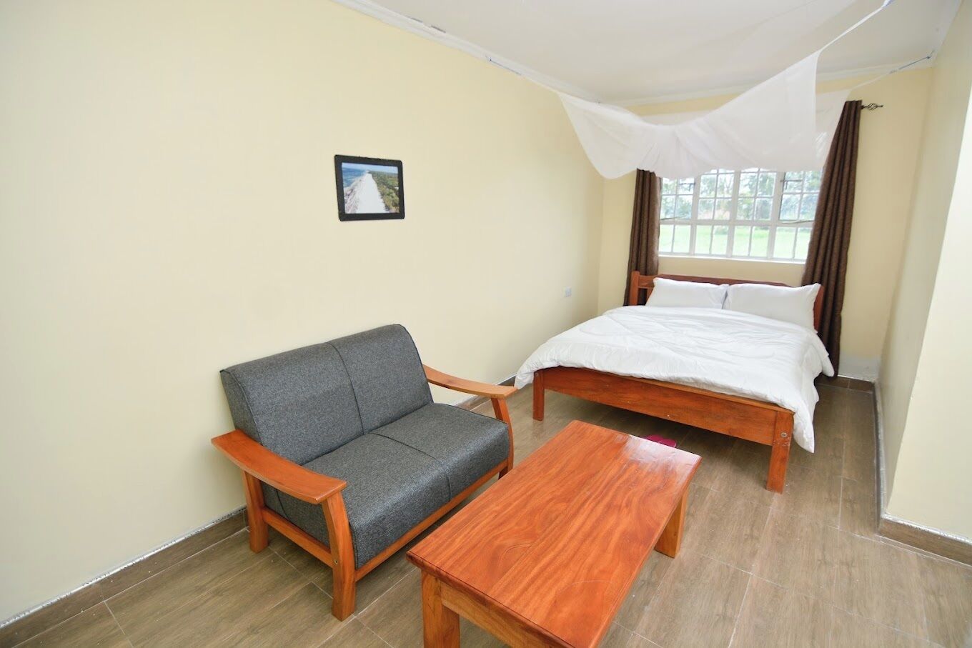 A room with a bed, a sofa, and a small table.